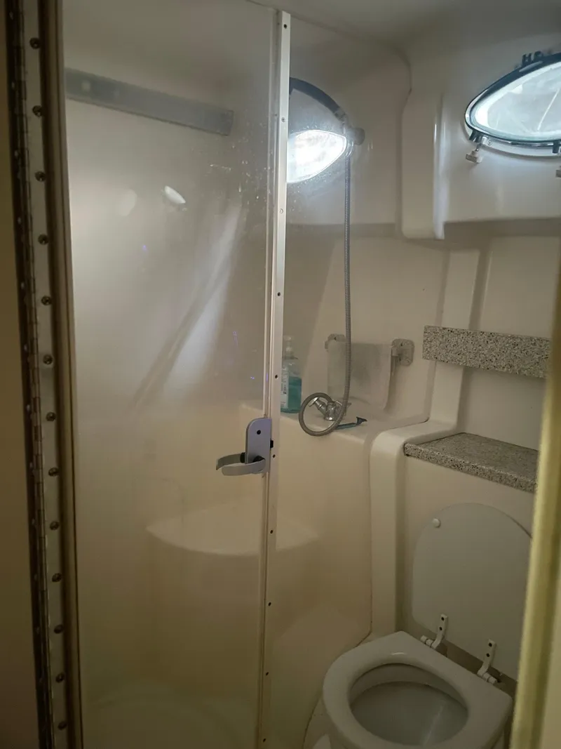 Slide: The Image of Bathroom in 2000 Rinker 330 Fiesta Vee boat with shower and toilet. - 23