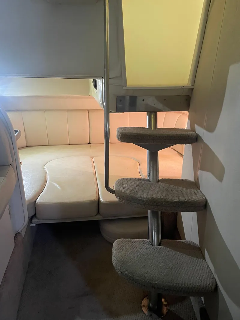 Slide: The Image of Interior cabin of 2000 Rinker 330 Fiesta Vee with carpeted steps and seating area. - 25