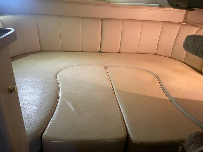 Slide: The Image of 2000 Rinker 330 Fiesta Vee cabin interior with beige seating. - 26