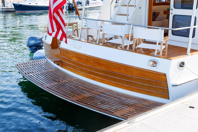 Slide: The Image of Grand Banks 43 Europa 2014 yacht with wooden deck and American flag at marina. - 14