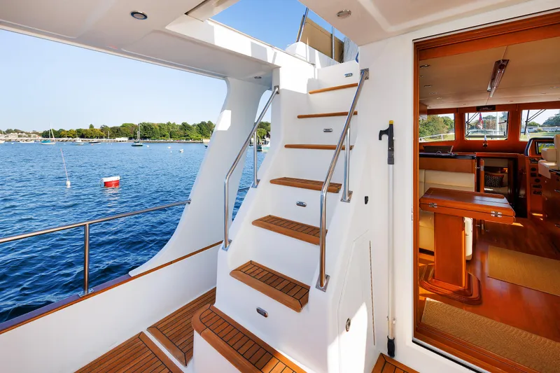 Slide: The Image of Grand Banks 43 Europa 2014 yacht interior with wooden stairs and scenic water view. - 19