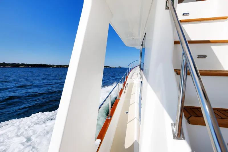 Slide: The Image of Side view of 2014 Grand Banks 43 Europa yacht cruising on open water. - 22