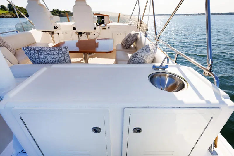 Slide: The Image of Flybridge of 2014 Grand Banks 43 Europa yacht with seating and sink, overlooking water. - 31