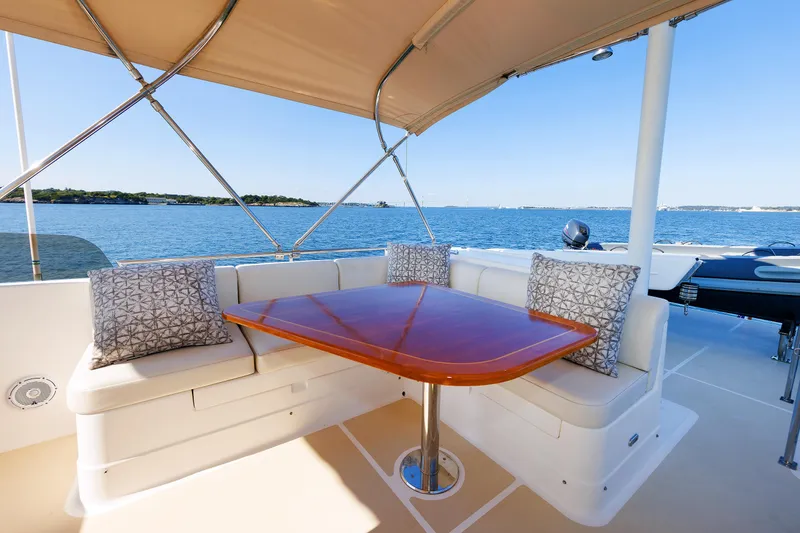 Slide: The Image of Grand Banks 43 Europa 2014 yacht deck with seating and table, ocean view. - 38