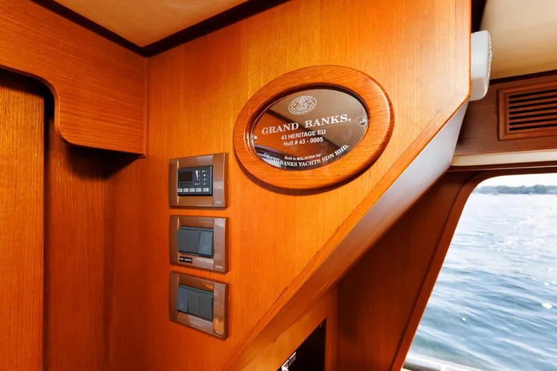 Slide: The Image of Interior of 2014 Grand Banks 43 Europa yacht with wood paneling and control panels. - 48