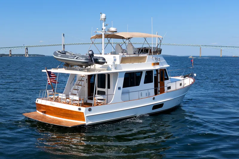 Slide: The Image of 2014 Grand Banks 43 Europa yacht cruising on open water with bridge in background. - 6