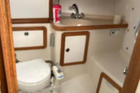 Slide: The Image of Bathroom interior of a 1998 Catalina 36 MkII sailboat, featuring sink and toilet. - 14