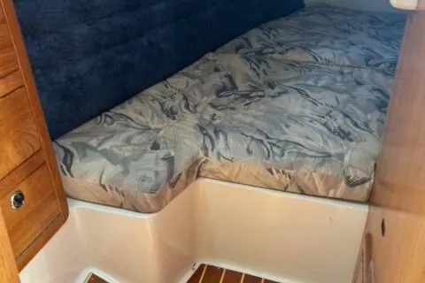 Slide: The Image of Interior cabin of a 1998 Catalina 36 MkII sailboat with a patterned bed. - 3