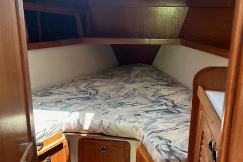 Slide: The Image of Cozy cabin interior of 1998 Catalina 36 MkII sailboat with patterned bedding. - 4
