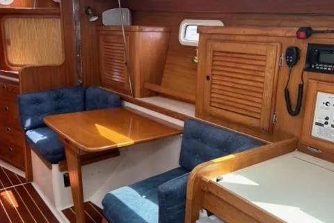 Slide: The Image of Interior of 1998 Catalina 36 MkII sailboat with wooden cabinetry and blue seating. - 7