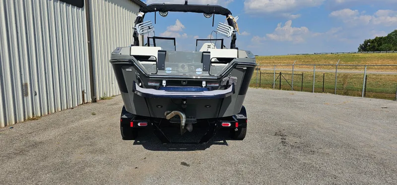 Slide: The Image of 2024 Heyday H20 boat parked on concrete near a metal building under a blue sky. - 4