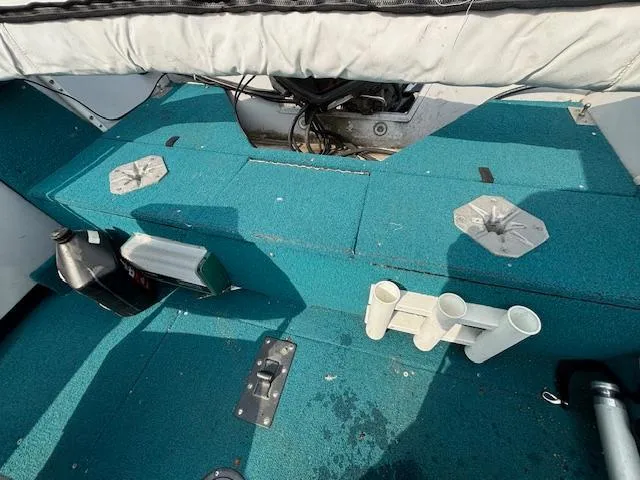 Slide: The Image of 1995 Crestliner 1750 SPORT FISH boat interior with teal carpet and fishing rod holders. - 11