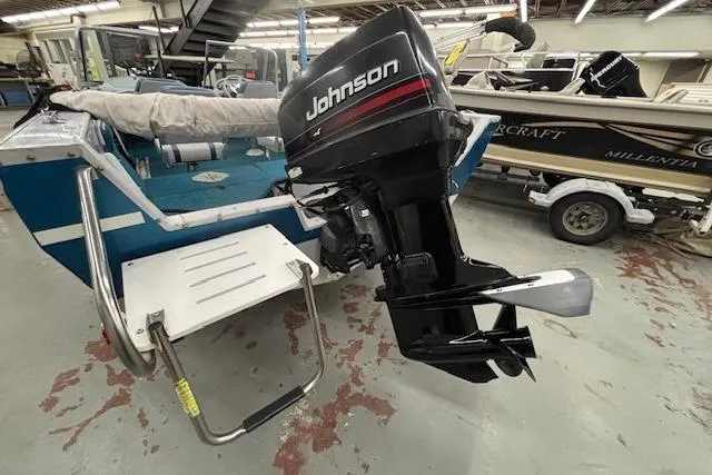 Slide: The Image of 1995 Crestliner 1750 SPORT FISH boat with Johnson outboard motor in a garage setting. - 2