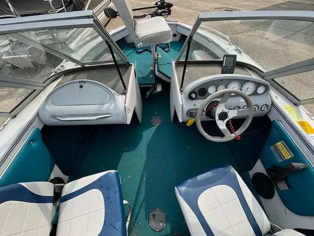 Slide: The Image of 1995 Crestliner 1750 Sport Fish boat interior with steering wheel and seating. - 23