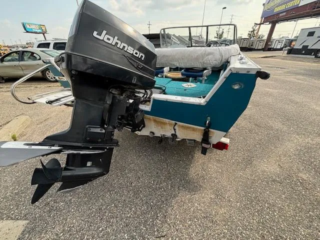 Slide: The Image of 1995 Crestliner 1750 Sport Fish boat with Johnson outboard motor in parking lot. - 27