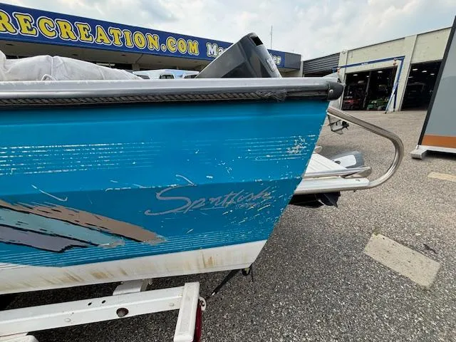 Slide: The Image of 1995 Crestliner 1750 SPORT FISH boat with blue exterior, showing wear, parked outdoors. - 29