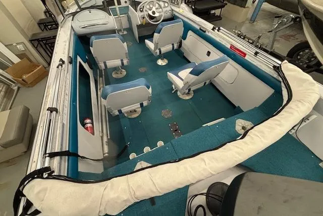 Slide: The Image of 1995 Crestliner 1750 SPORT FISH boat interior with blue seating and steering wheel. - 31