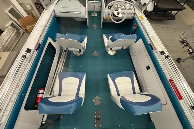 Slide: The Image of 1995 Crestliner 1750 SPORT FISH boat interior with blue and white seating and steering console. - 32