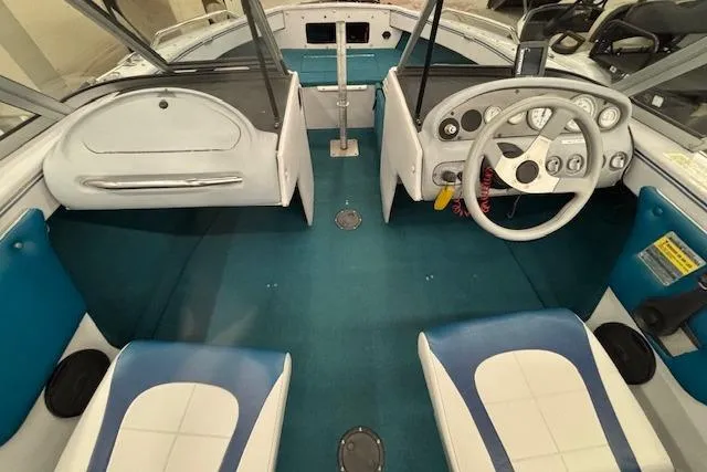 Slide: The Image of 1995 Crestliner 1750 SPORT FISH boat interior with blue and white seating and steering console. - 33