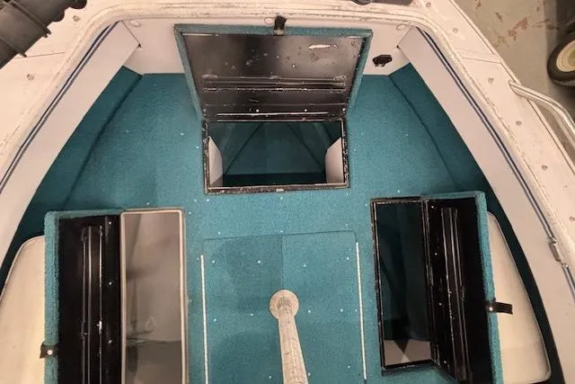 Slide: The Image of 1995 Crestliner 1750 SPORT FISH boat interior with blue carpet and storage compartments. - 40
