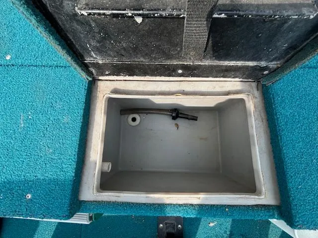 Slide: The Image of Open storage compartment in 1995 Crestliner 1750 SPORT FISH boat with blue carpet. - 8