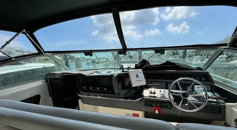 Slide: The Image of Interior view of 1990 Sea Ray 350 Sundancer boat cockpit with steering wheel. - 15