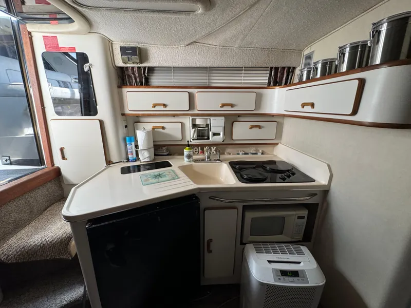 Slide: The Image of Compact kitchen in a 1990 Sea Ray 350 Sundancer boat with modern amenities. - 17