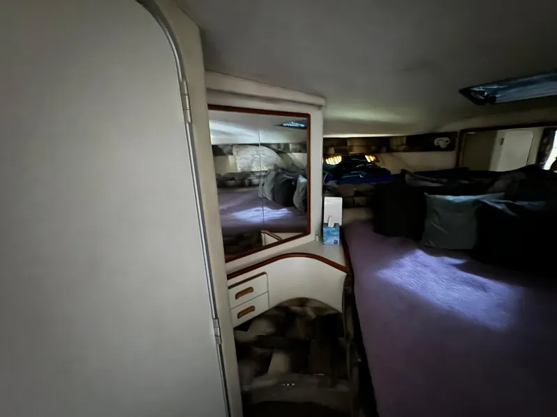 Slide: The Image of Interior cabin of 1990 Sea Ray 350 Sundancer with bed and mirror. - 25