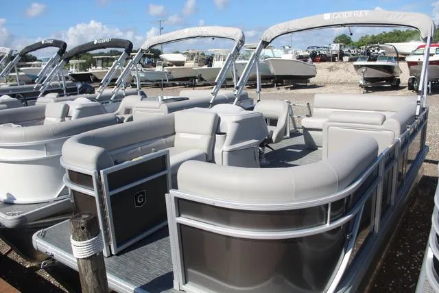 Slide: The Image of 2025 Godfrey Pontoons Xperience 1680 CX, luxury pontoon boat in marina setting. - 3