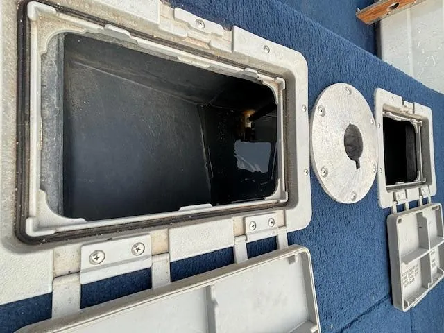 Slide: The Image of Open storage compartments on 1990 Smoker Craft Resorter boat deck. - 10