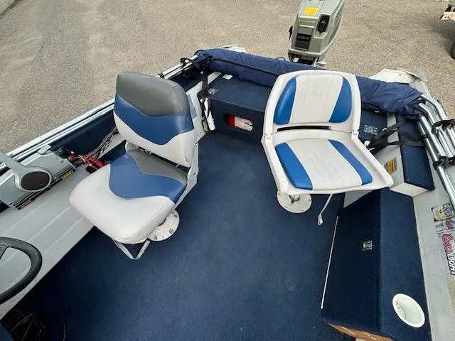 Slide: The Image of 1990 Smoker Craft Resorter boat interior with blue and white seating. - 3