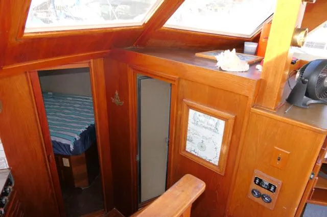 Slide: The Image of Interior of 1988 Jersey 36 Convertible Sportfisher with sofa, table, and carpeted floor. - 10
