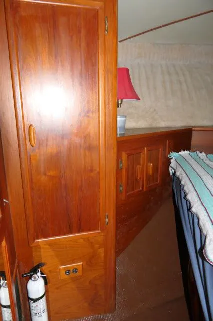 Slide: The Image of Interior of 1988 Jersey 36 Convertible Sportfisher with chair, mini-fridge, and wooden cabinetry. - 12