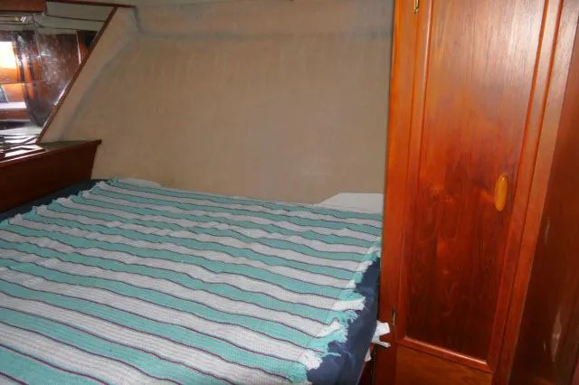 Slide: The Image of 1988 Jersey 36 Convertible Sportfisher kitchen with wood cabinets, stove, and sink. - 14