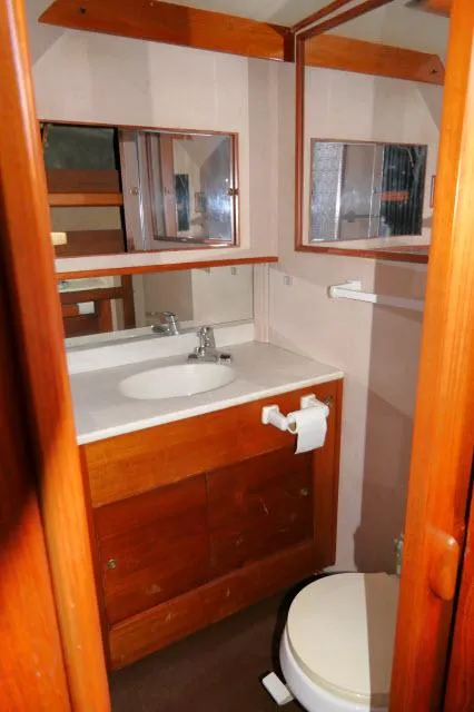 Slide: The Image of Interior of 1988 Jersey 36 Convertible Sportfisher with wood paneling and cabin access. - 15