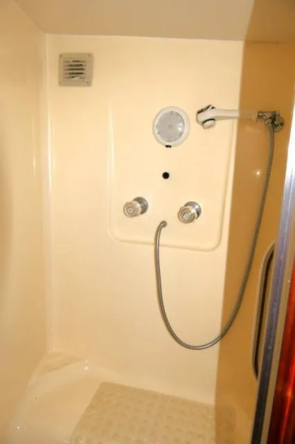 Slide: The Image of Cozy cabin bed with striped blanket in 1988 Jersey 36 Convertible Sportfisher. - 18