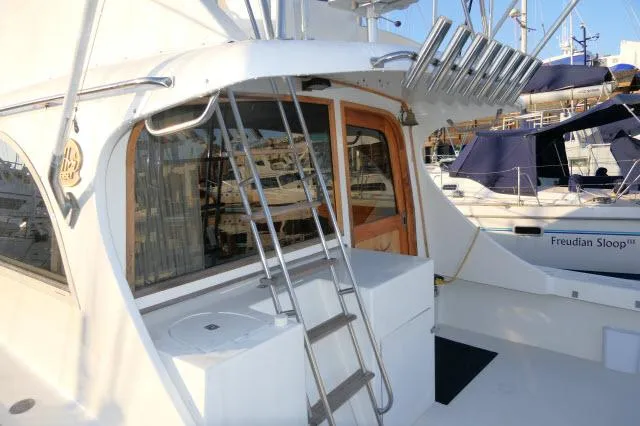 Slide: The Image of 1988 Jersey 36 Convertible Sportfisher bathroom with sink, toilet, and wooden cabinetry. - 20