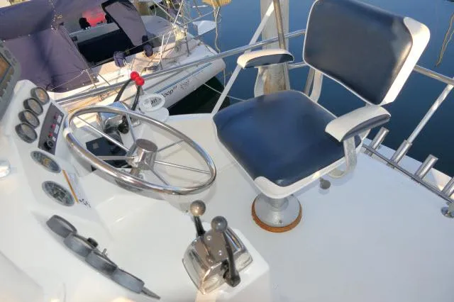 Slide: The Image of 1988 Jersey 36 Convertible Sportfisher boat with ladder and wooden door in marina. - 26