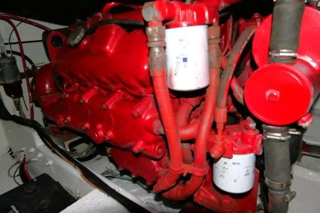 Slide: The Image of Red engine of a 1988 Jersey 36 Convertible Sportfisher boat, showcasing detailed components. - 36