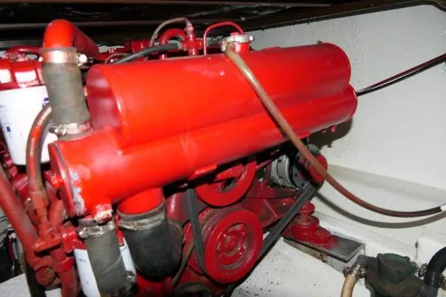 Slide: The Image of Engine of 1988 Jersey 36 Convertible Sportfisher, featuring red components and hoses. - 37
