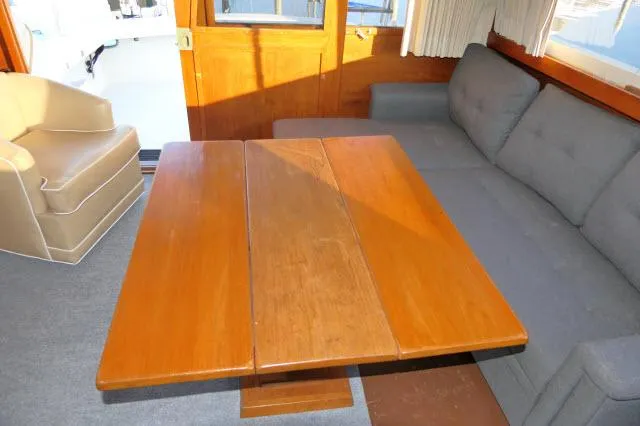 Slide: The Image of Interior of 1988 Jersey 36 Convertible Sportfisher with beige chair and wooden furnishings. - 5