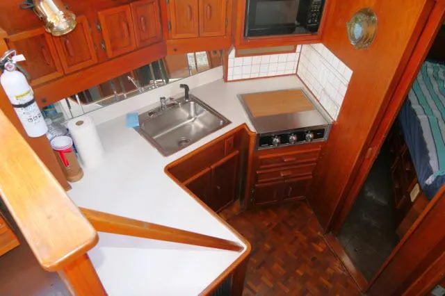 Slide: The Image of Interior of 1988 Jersey 36 Convertible Sportfisher with gray sofa and wooden table. - 7