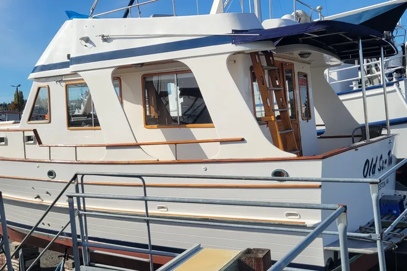 Slide: The Image of 1982 CHB Oceans boat docked, featuring classic design and wooden accents. - 12