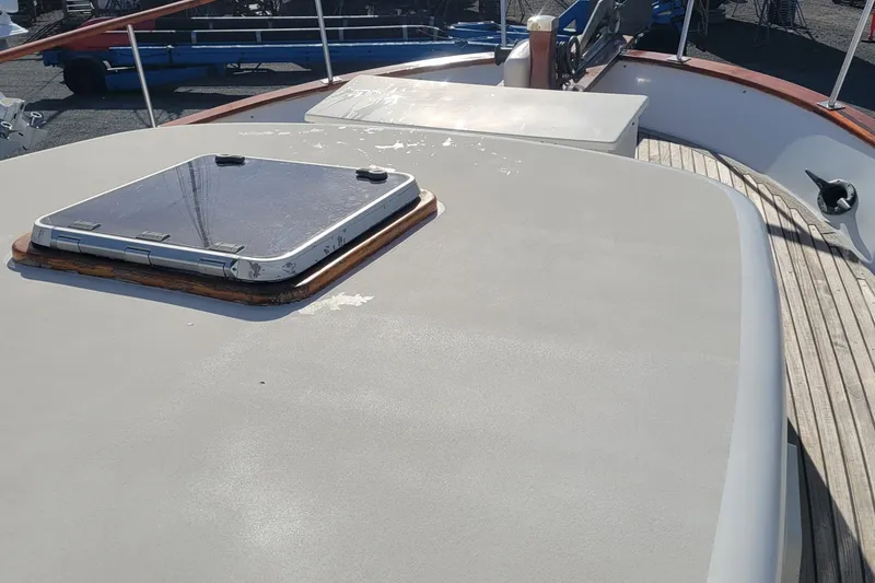 Slide: The Image of 1982 CHB Oceans boat deck with hatch, featuring wooden and metal elements. - 13
