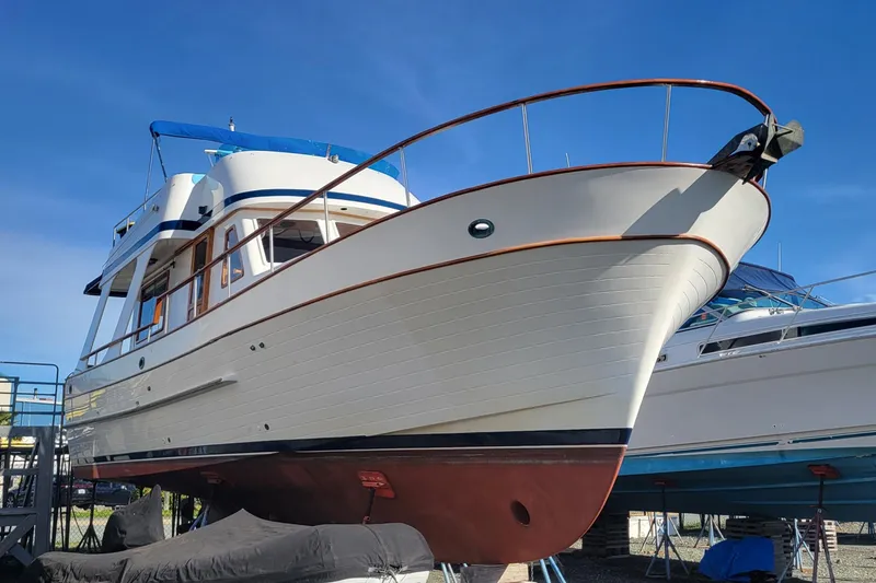 Slide: The Image of 1982 CHB Oceans boat on dry dock under clear blue sky. - 17