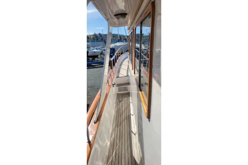 Slide: The Image of Side deck view of 1982 CHB Oceans boat with wooden railings and windows. - 18