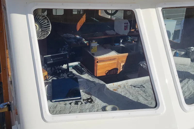 Slide: The Image of Interior view of 1982 CHB Oceans boat with navigation equipment and kitchen area. - 27