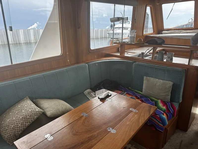 Slide: The Image of Interior of 1982 CHB Oceans boat with cozy seating and wooden table. - 7
