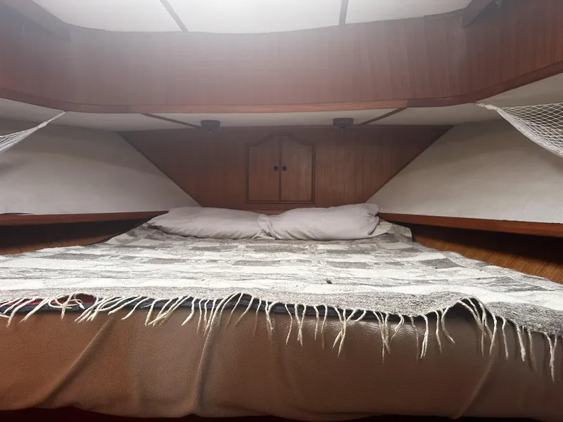 Slide: The Image of Cozy cabin bedroom in 1982 CHB Oceans boat with wooden interior and comfortable bedding. - 9