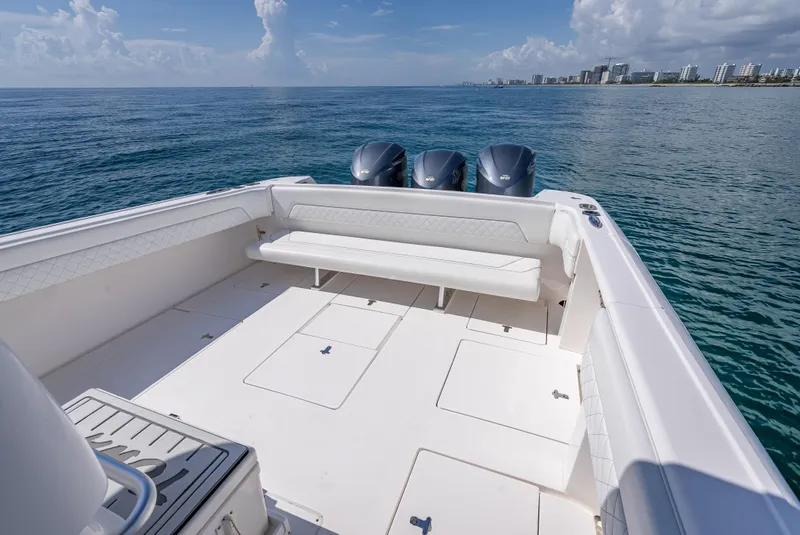 Slide: The Image of 2017 Intrepid 400 Center Console boat with triple engines on open water. - 19